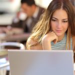 woman on laptop in coffee shop spss online learning concept