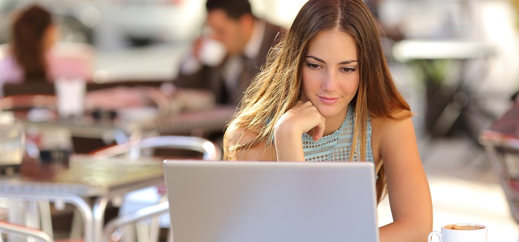 woman on laptop in coffee shop spss online learning concept