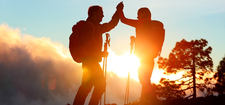 Hikers at the Top Celebrating Success Concept