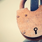 Big Vintage Rusty Padlock On Fence