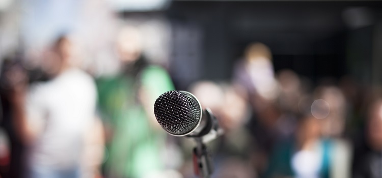 Social media analytics concept microphone with audience